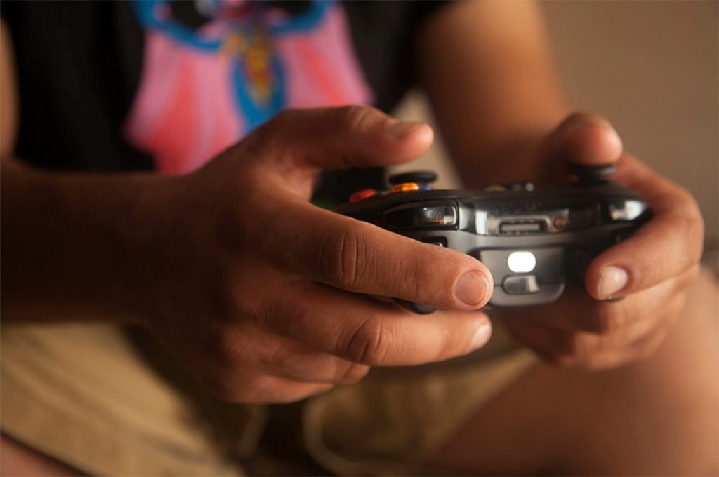person holding black game controller
